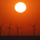 The sun sets behind the wind turbines of Burbo Bank Offshore Wind Farm in the Irish Sea on May 23, 2018.